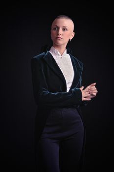 Young woman in tailcoat on black background