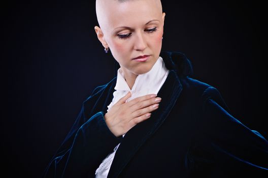 Bald young woman posing in studio