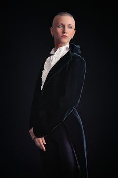 Young woman in tailcoat on black background
