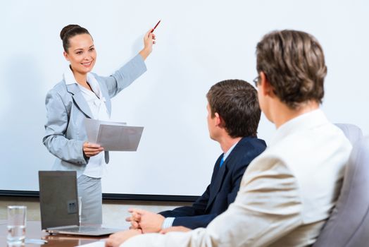 image of a Business woman showing a presentation to colleagues