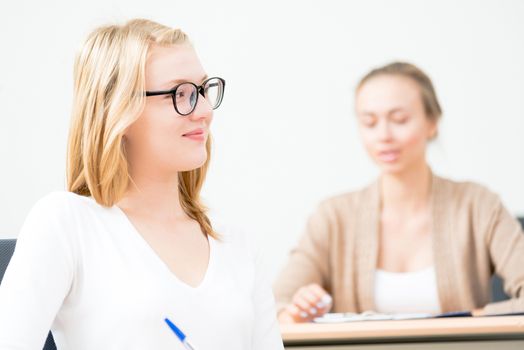 image of a young female students in the classroom, teaching at the University of