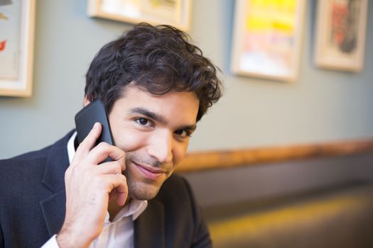 smiling male cheerful restaurant smartphone