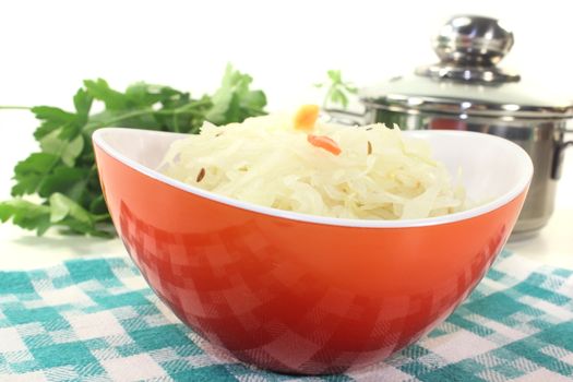 sourcrout in a bowl on light background