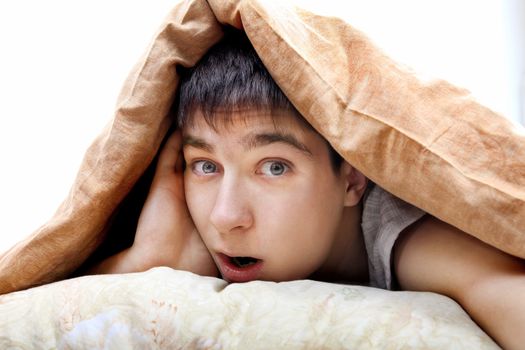 Surprised Teenager under Blanket at the Home