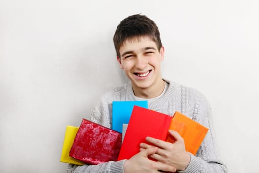Cheerful Teenager with a Books at the Home