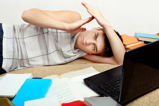 Tired Student on Sofa showing Time Out Gesture