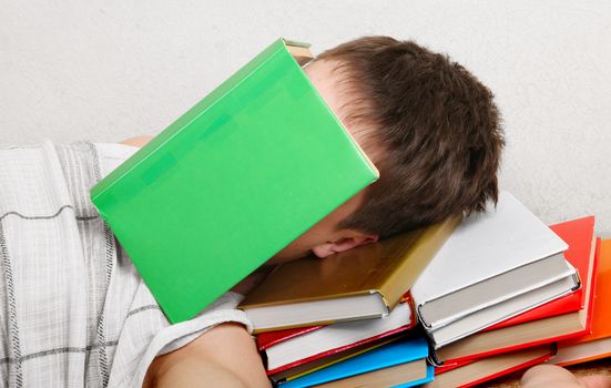 Teenager sleeps with the Books at the Home