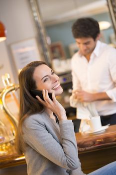 pretty smiling female cell phone restaurant calling