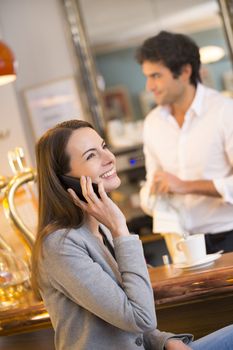 pretty smiling female cell phone restaurant calling