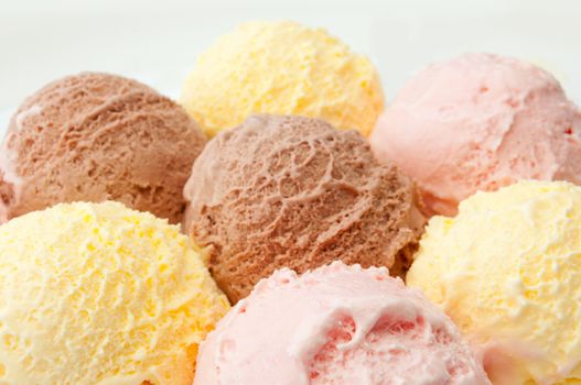 Icecream scoops with chocolate, vanilla and strawberry flavors 