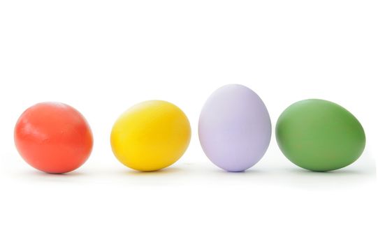 Painted easter eggs lined up in a row over a white background 