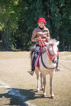 Asia women on horseback