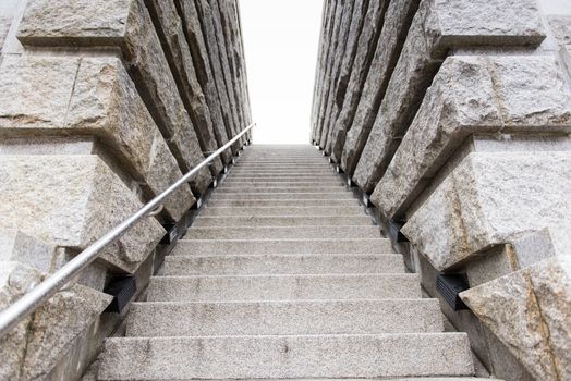 Stone stairs leading upwards into a white sky outdoors