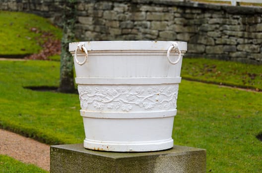 an old garden pot made ​​of metal with a beautiful pattern