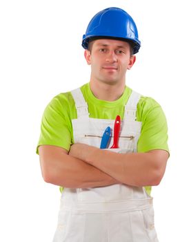 a men wearing working clothes with paint brushes in pocket and crossed arms looking at camera   isolated