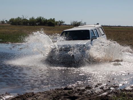 Car passing the ford (Savuti Marsh, Chobe National Park, Botswana)