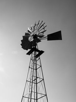 Typical african waterhole windmill in black and white