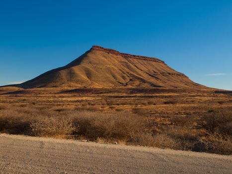 Gravel road and table mountain in southern Namibia