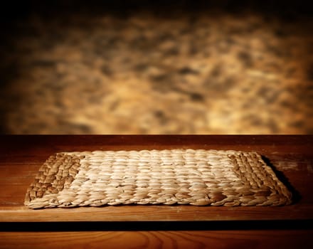 Empty wooden table and defocused brown wall