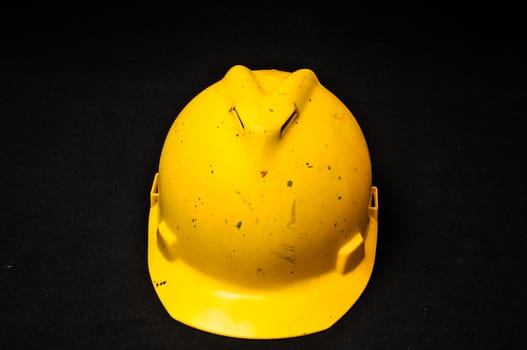 Yellow Safety Helmet on a Black Background