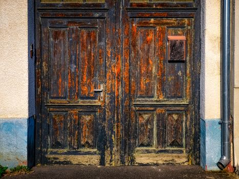 Detail of old weathered and textured wooden door entrance