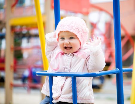 fun little baby swinging at the park