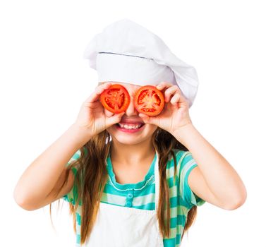 little girl in chef hat with tomatoes near the eye