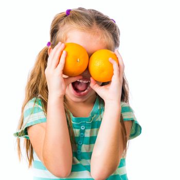 little girl with two oranges isolated on white background