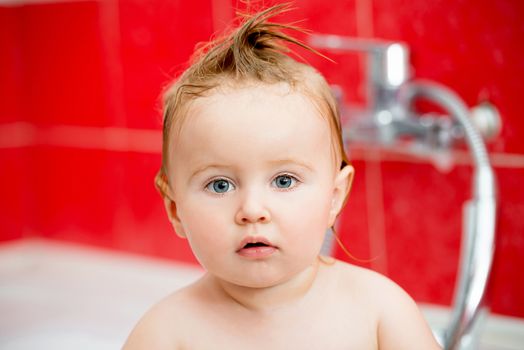 adorable little baby taking a bath