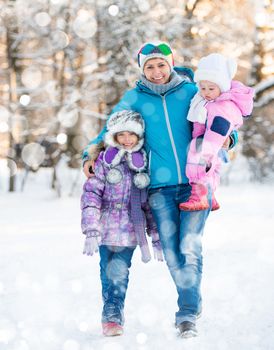 Happy mother with two kids on a winter walk