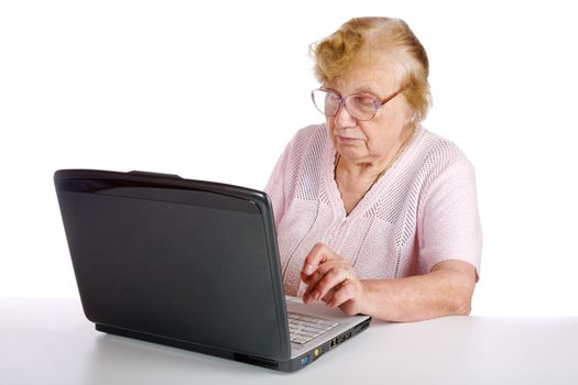 granny in glasses looks at the screen notebook on a white background