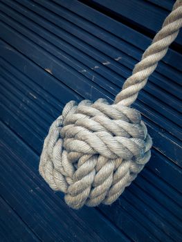 Nautical knot on a blue wooden background