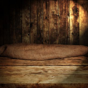 Empty wooden table and dark brown wall in background