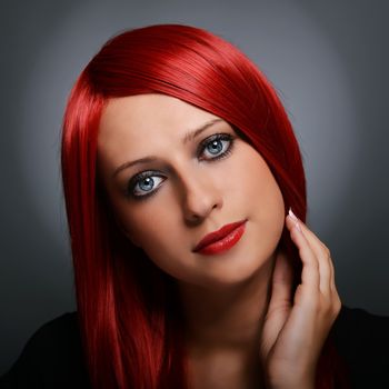Beautiful red haired girl over gray background