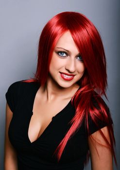 Beautiful red haired girl over gray background