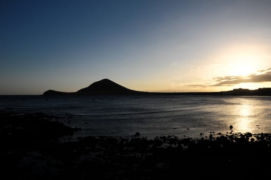 Sunset on the Atlantic Ocean with a Mountain in Background El Medano Tenerife Canary Islands Spain