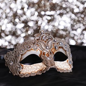 Carnival mask on black silk background