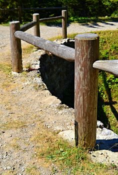 old wooden fence with tree trunks around the periphery the bridge