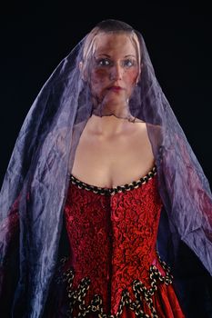 Woman in baroque costume with voile on black background