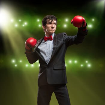 image of a businessman with boxing gloves in the ring, the competition in the business