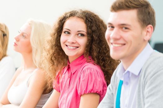 attractive young woman looking at a neighbor left in the classroom