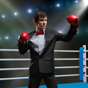 image of a businessman with boxing gloves in the ring, the competition in the business