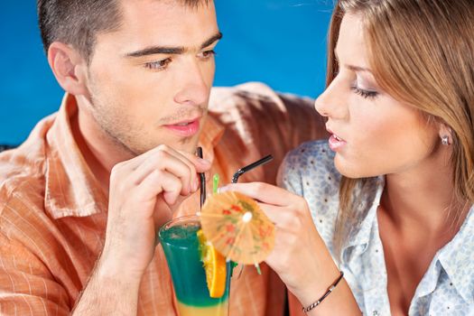 young couple outdoor drinking cocktail on summer evening