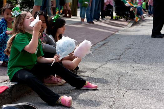 Atlanta, GA - March 15, 2014:  Kids eat cotton candy at the annual Atlanta St. Patrick's parade.