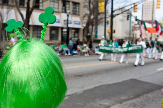 Atlanta, GA - March 15, 2014:  A person wearing a green wig watches the annual Atlanta St. Patrick's parade go by.
