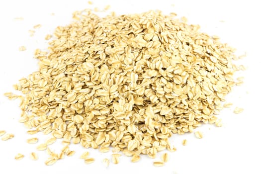 Heap of dry rolled oats isolated on white background 