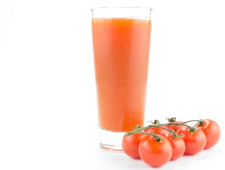 Drinking glass with tomato juice and ripe fresh tomato on the white background 