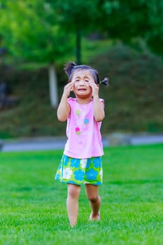 Adorable girl upset and cry in the park