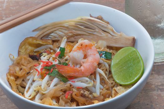 Fried noodle wrapped with eggs, Thai style food, (Pad thai)