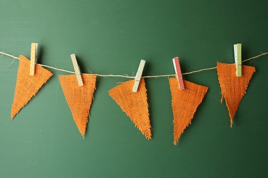 Orange Burlap Pennants Hanging on a Green Chalkboard